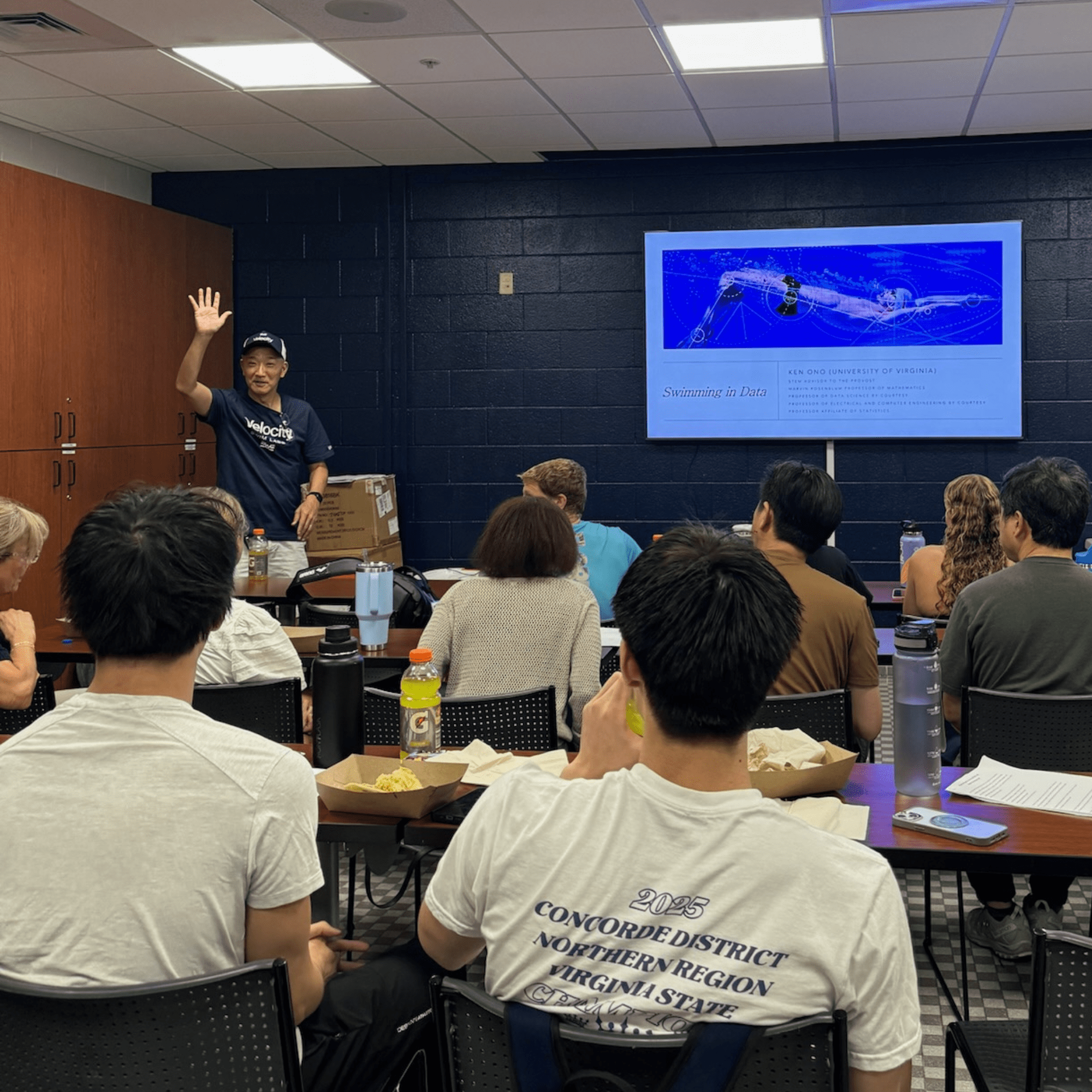 Dr. Ken Ono presenting swimming data analysis to camp attendees