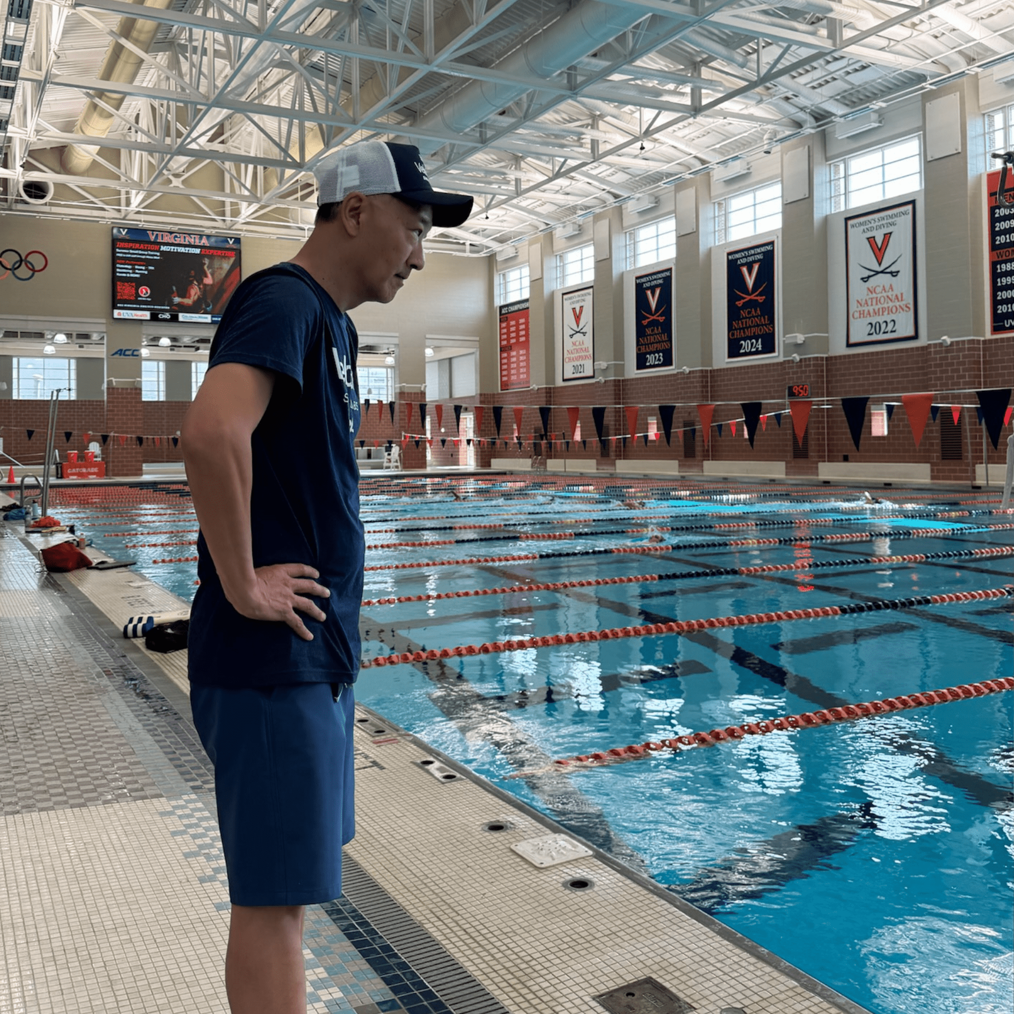 Coach observing swimmers during testing session at UVA pool
