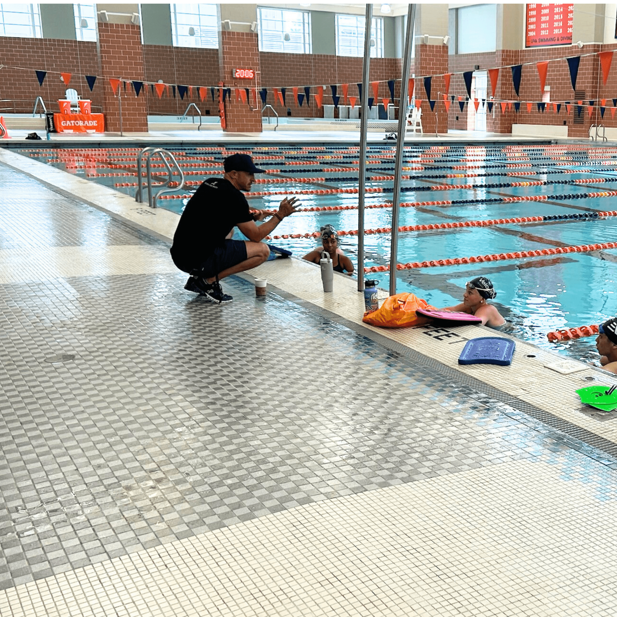 Todd DeSorbo providing personalized coaching to swimmers in the pool