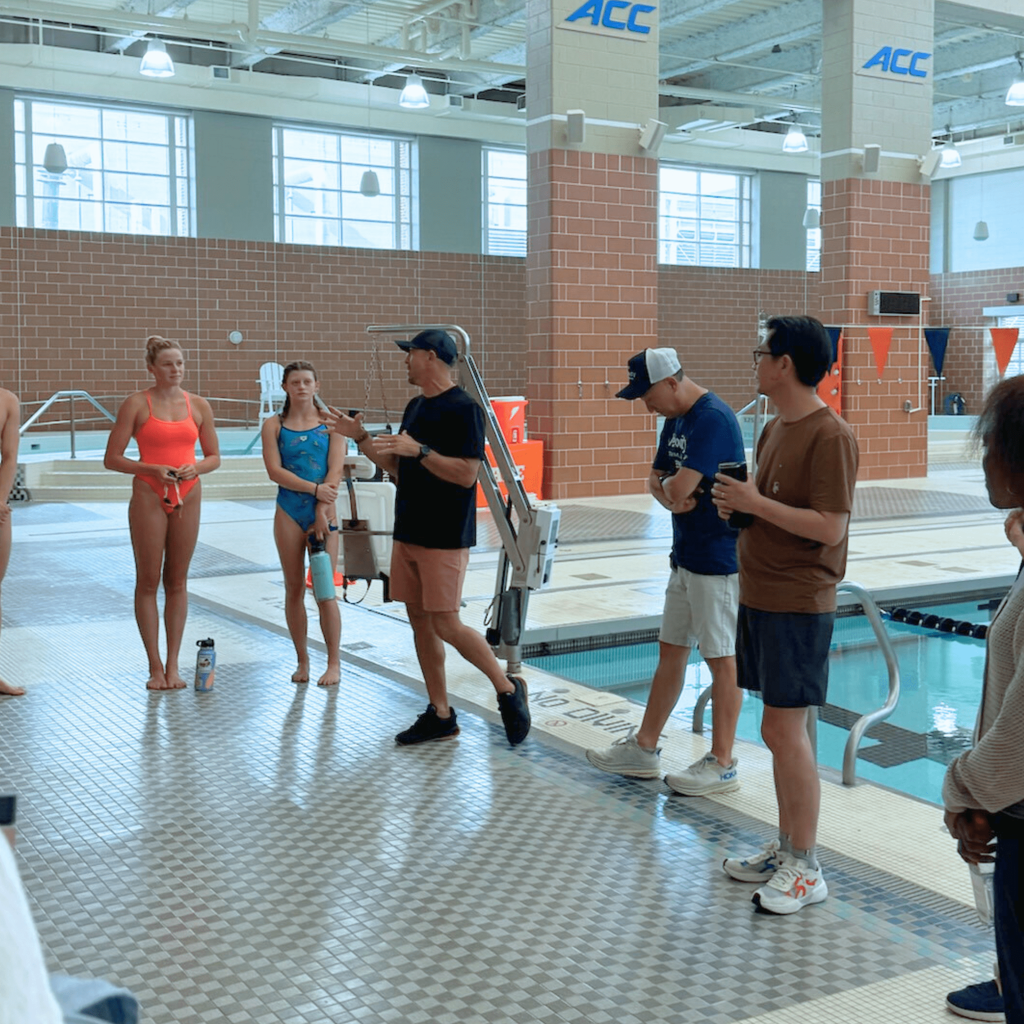 Todd DeSorbo and team presenting technique analysis to swimmers