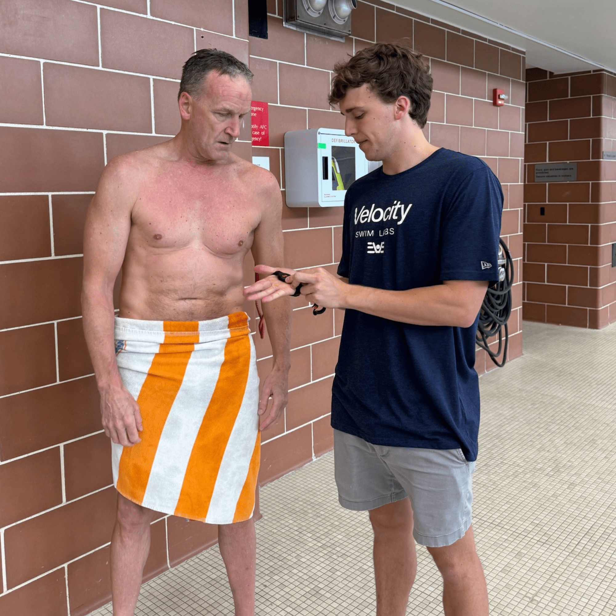 Team member attaching sensors to swimmer for biomechanical testing